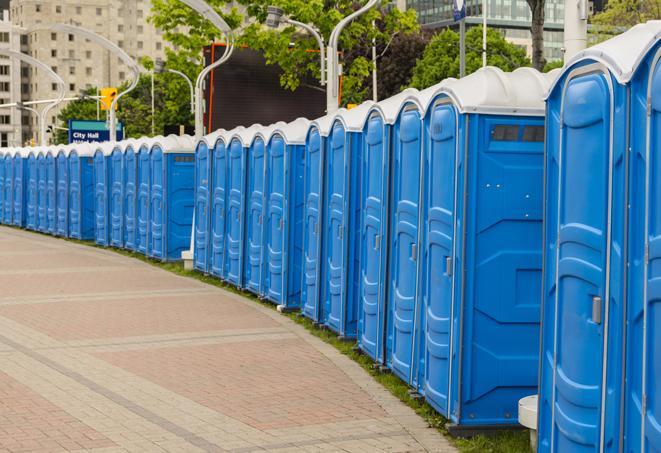 hygienic portable restrooms lined up at a beach party, ensuring guests have access to the necessary facilities while enjoying the sun and sand in Bloomington